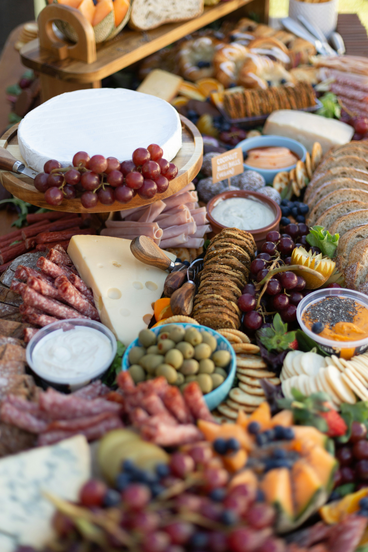Grazing table with cheeses, charcuterie, and breads